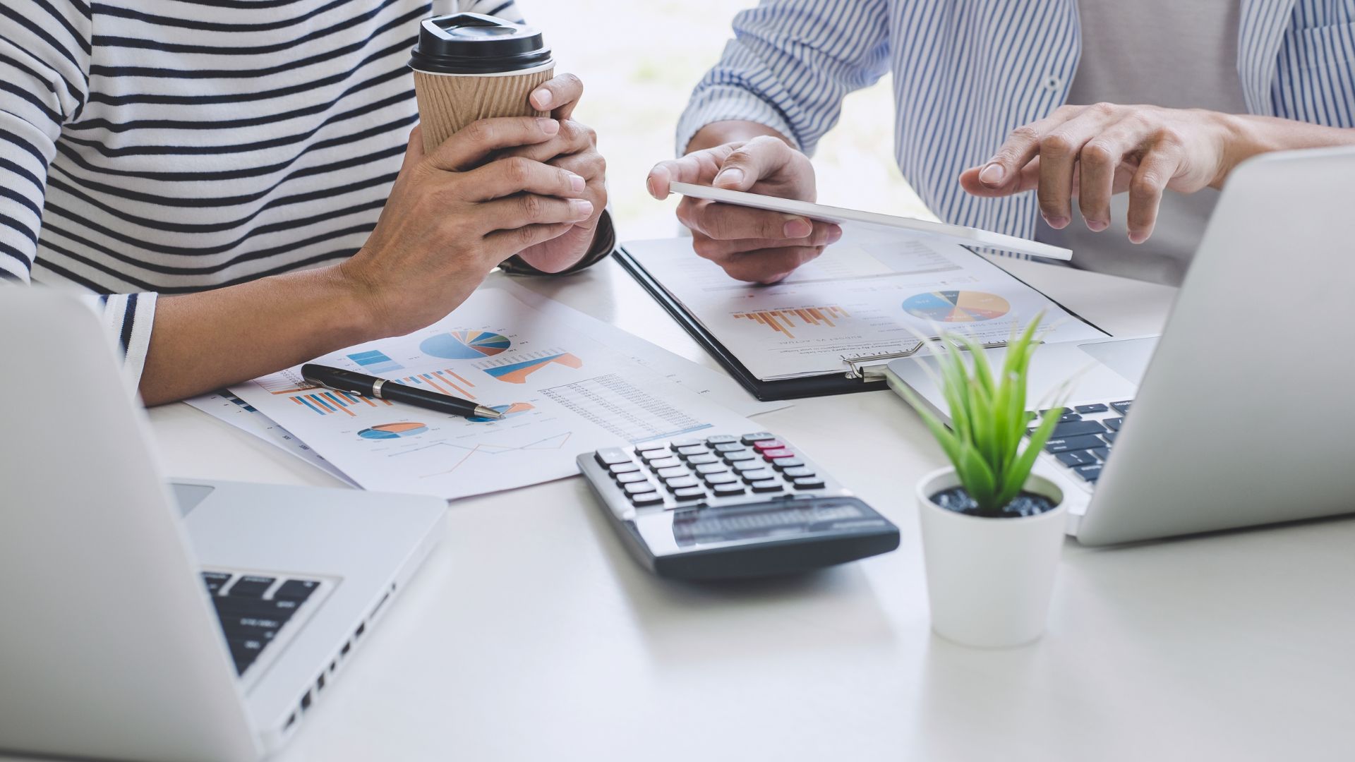 Business professionals analyzing charts and data during strategy meeting